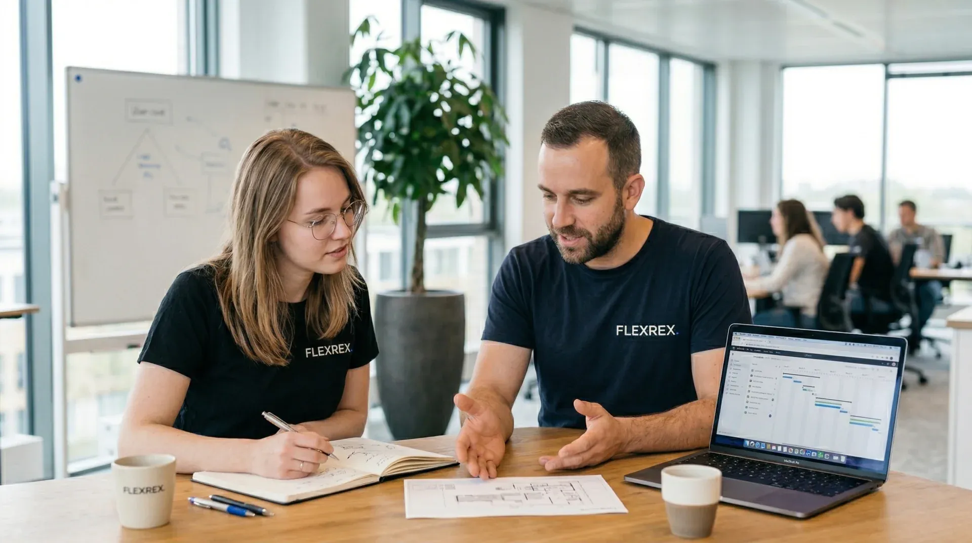 Two team members planning a project at a desk